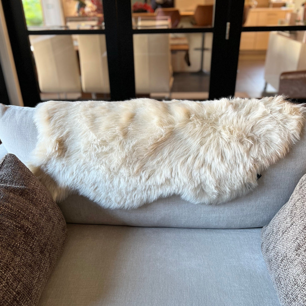 natural snug faux sheepskin rug on sofa back